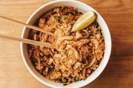 Thai noodle Pad Thai bowl background. Traditional rice noodles with shrimp and seafood. Asian food...