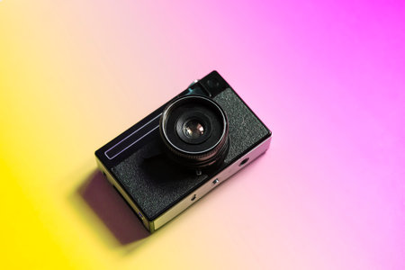 Vintage film camera on a color minimal background. Photography, hipster lifestyle concept