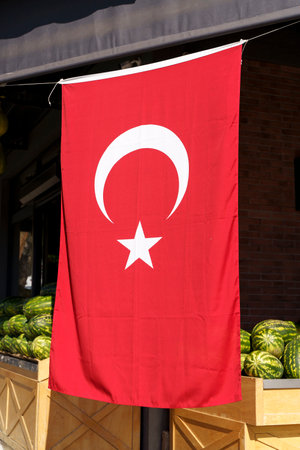 Turkish flag background. Red textile flag of Turkey on the streets of Istanbul on the holidays of patriotism and independence of the republic. Culture, nation, state.の写真素材