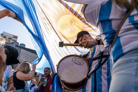 Buenos Aires, Argentina - December 18, 2022: Happy Argentine football fans celebrate winning a final...