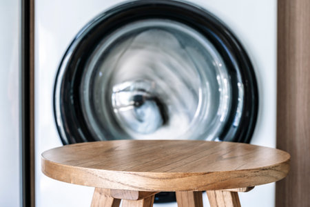 Laundry room table background. Blurred home laundry room with wooden table display for product.の写真素材