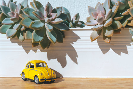 Travel car concept. Toy yellow car moves on against the backdrop of nature. Driving, adventure, discovery ideaの写真素材