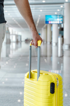 Traveling man with a suitcase at the airport. Vacation, planes, flights, travel concept.の写真素材
