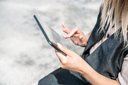 Woman businesswoman with a tablet works with financial data in the business of the city. Technology,...