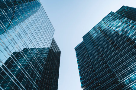 Business skyscrapers and office business center building architecture in perspective on blue sky. Economy, exchange, finance concept.の写真素材