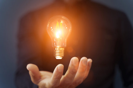 Knowledge idea bulb concept. Electric light bulb in hand business manager. Innovation, brain,...