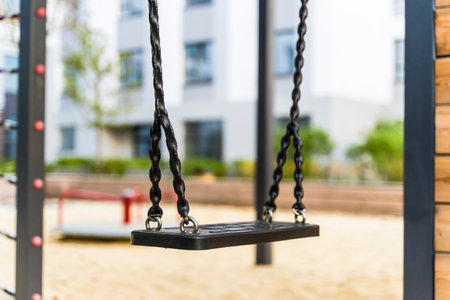 Swings on playground. Modern safe swing in a public parkの写真素材
