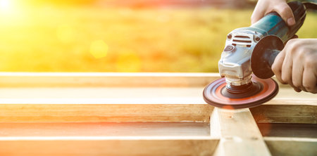 Wood sanding, furniture restoration and restoration. A carpenter sands an old window in his workshop.の写真素材
