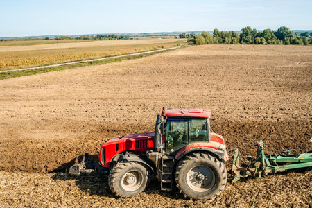 Tractor in the field. Agricultural machinery. Agricultural farm tractor during tillage of soil and...