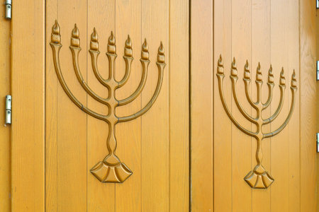 Menorah symbol on the door of an Israeli Jewish synagogue. Judaism religion symbolの写真素材