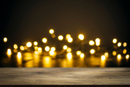 Christmas background table. Lights on backdrop with wooden tableの写真素材