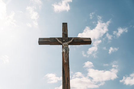 Crucifixion of Christ against the sky background. Catholicism, Christianity, faith concept. The initialism INRI Iesus Nazarenus, Rex Iudaeorum represents the Latin inscription in English translates to Jesus the Nazarene, King of the Jewsの写真素材