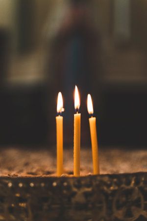 Candles in a Christian church during prayer or church service. Faith, God conceptの写真素材