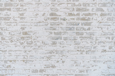 Old white brick wall background. Old plaster on stone brick wallの写真素材