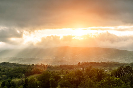 Sunset over hills landscape. Beautiful idealistic summer evening landscape somewhere in Europeの写真素材