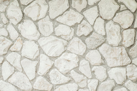 White masonry stone wall background pattern. Wall of an old building or castleの写真素材