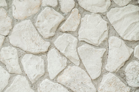 White masonry stone wall background pattern. Wall of an old building or castleの写真素材