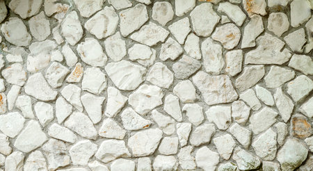 White masonry stone wall background pattern. Wall of an old building or castleの写真素材