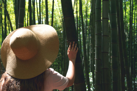 Girl in Straw Hat Exploring Bamboo Forest in Asia