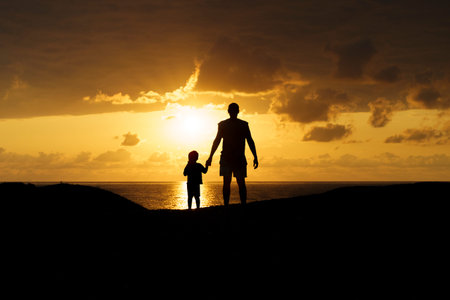 Father and Son Silhouettes at Sunset. Family Bonding Moment