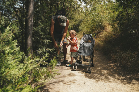 Father and Toddler Spending Time in Summer Forestの写真素材