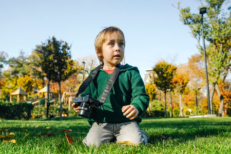 Child Learning Photography with Camera in Natureの写真素材