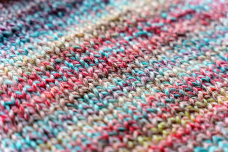 Close-up Texture of Handmade Knitted Clothing with Colorful Yarn Patterns