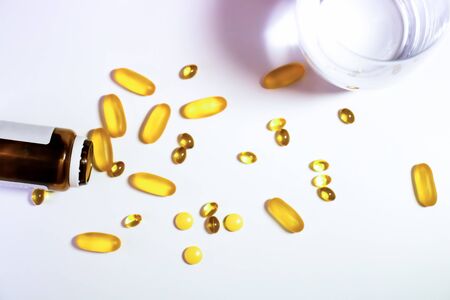 Assorted pharmaceutical medicine pills, tablets and capsules and bottle on blue background. Copy space for textの写真素材