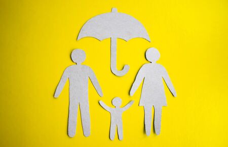 Paper cut of family with house and car on green grassの写真素材