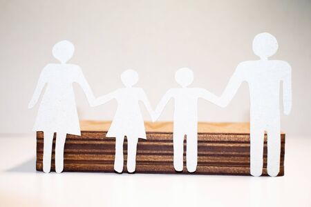 Paper cut of family with house and car on green grassの写真素材