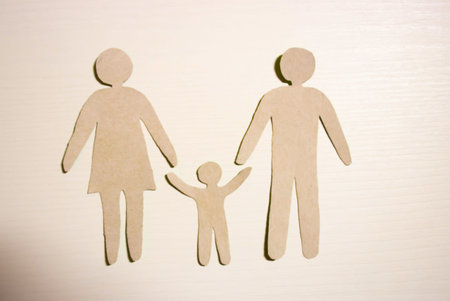 Paper cut of family with house and car on green grassの写真素材