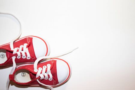 Red sneakers top view close up isolated on white backgroundの写真素材
