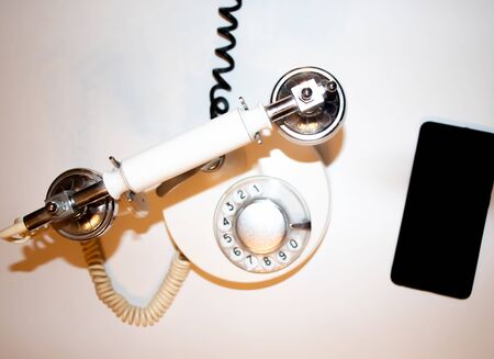 old telephone and smart phone on white backgroundの写真素材
