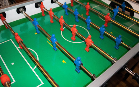 Table football game with yellow and blue players
