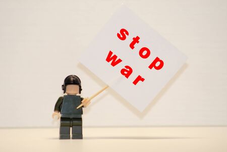 Stalker in gas mask with precaution stop signboardの写真素材