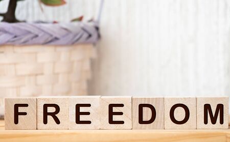 Word freedom written on wooden blocks, close upの写真素材