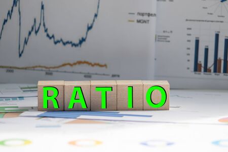 Block of alphabet letters forming the word RATIO on wooden surface.の写真素材