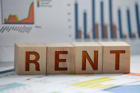 Wooden blocks with the word Rent, house and up arrow. The concept of the high cost of rent for an apartment or home. Interest rates are rising. Real estate market. Increased demand for rental propertyの写真素材