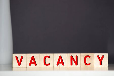 Vacancy word written on wood block. Vacancy text on wooden table for your desing, concept.の写真素材