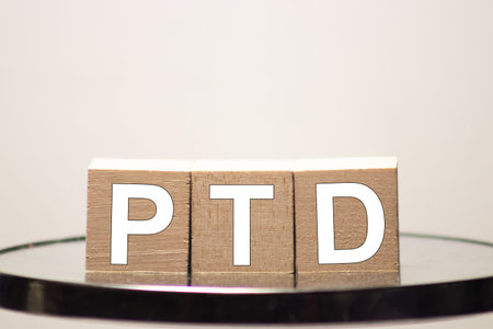 PTD Project To Date acronym on wooden cubes on dark wooden backround. Business concept.
