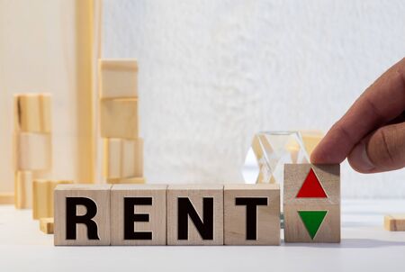 Wooden blocks with the word Rent, house and up arrow. The concept of the high cost of rent for an apartment or home. Interest rates are rising. Real estate market. Increased demand for rental propertyの写真素材