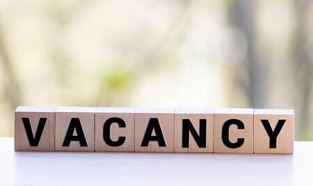 Vacancy word written on wood block. Vacancy text on wooden table for your desing, concept.の写真素材