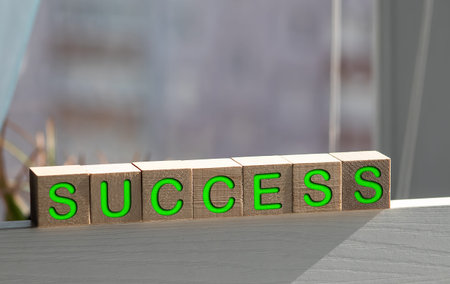 Colorful childrens blocks spelling out Success on a chalk board. Horizontal format.