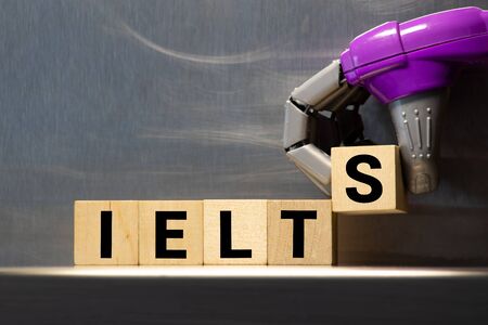 Wooden blocks with the word IELTS - international standardised test of English language.の写真素材