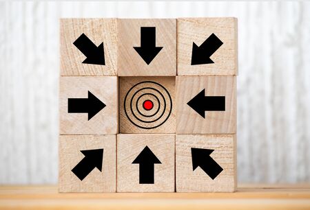 Wooden block with red arrow facing the opposite direction black arrows, Unique, think different, individual and standing out from the crowd conceptの写真素材
