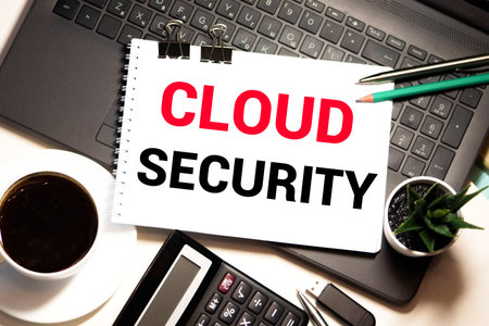 young man pointing at CLOUD SECURITY text on virtual screen. soft light with vintage filter....