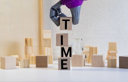 the concept of time. hand men in business suit holding the cubes which the written word time.の写真素材