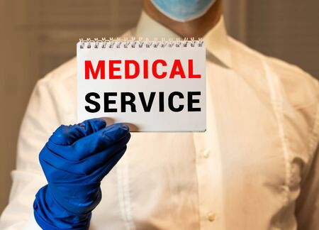 Medical Service word on tablet screen with medical equipment on backgroundの写真素材