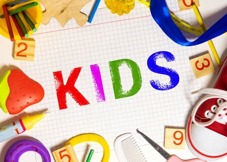The words 'kids zone' spelled out using colored fridge magnets, isolated on whiteの写真素材