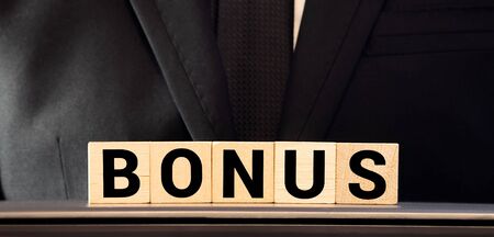 Man made word BONUS with wood blocksの写真素材